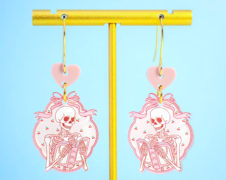Pink Skeleton Reading A Book Earrings